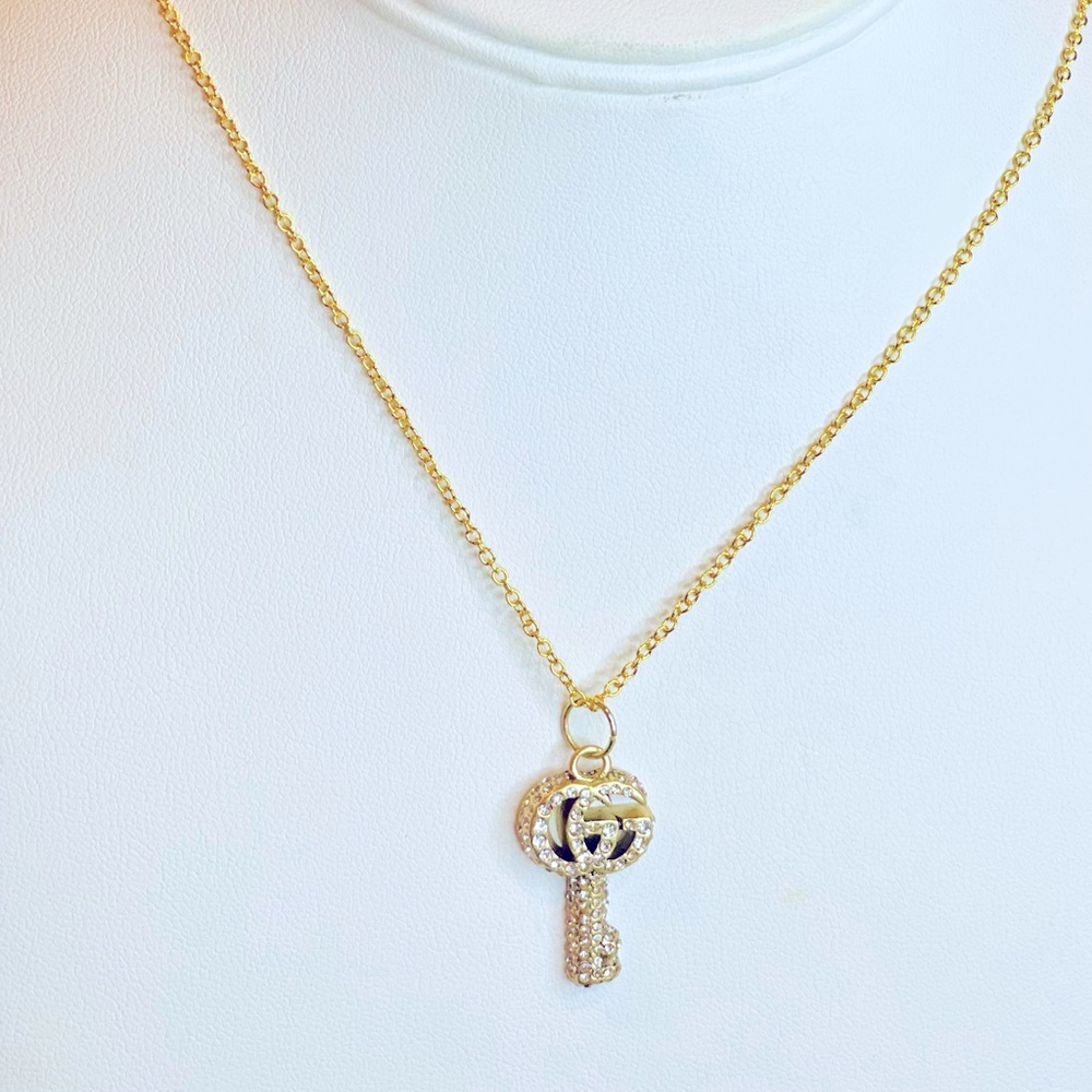 Gucci Gold Key. Stamped on the back. Attach it to a necklace or a bag charm